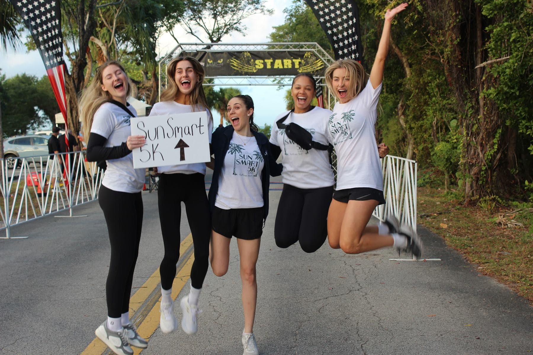 A group of friends jumping in the air at the start